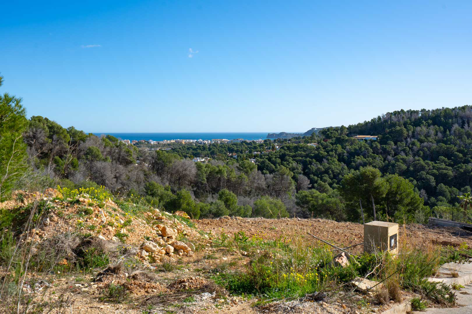 Vues panoramiques sur la mer et le littoral depuis le terrain en hauteur, entouré d'une forêt de pins méditerranéens et d'un paysage naturel préservé.