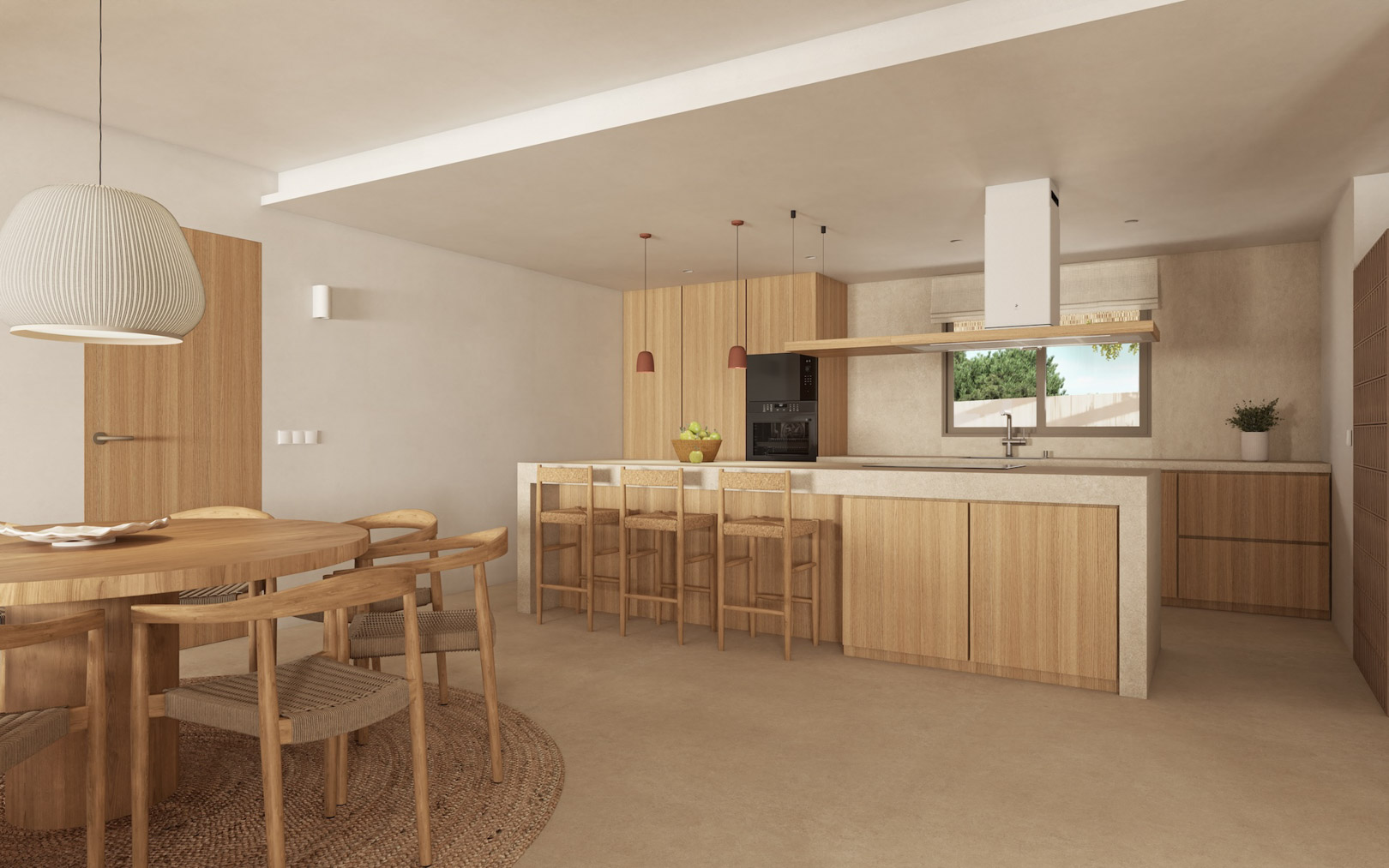 Cuisine à aire ouverte avec îlot en pierre, menuiserie en bois clair et coin repas comprenant une table ronde et des chaises en fibres naturelles.