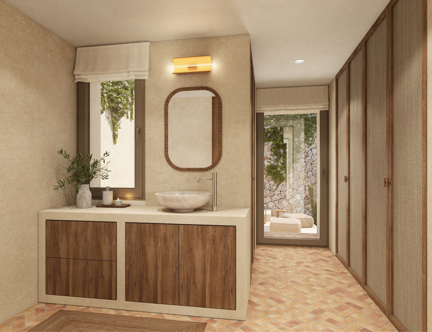 Salle de bain avec vasque en pierre, menuiserie en bois et sol en terre cuite. Armoires encastrées avec panneaux texturés et accès direct à un patio privé avec mur en pierre naturelle.