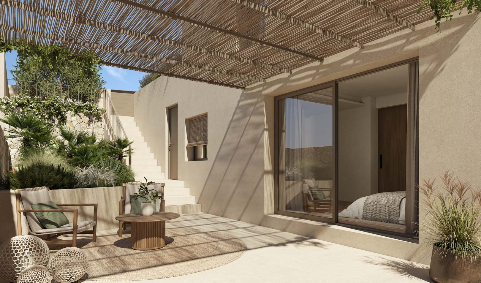 Terrasse extérieure avec pergola en canisse, coin salon en bois et accès direct à la chambre par de grandes baies vitrées coulissantes.