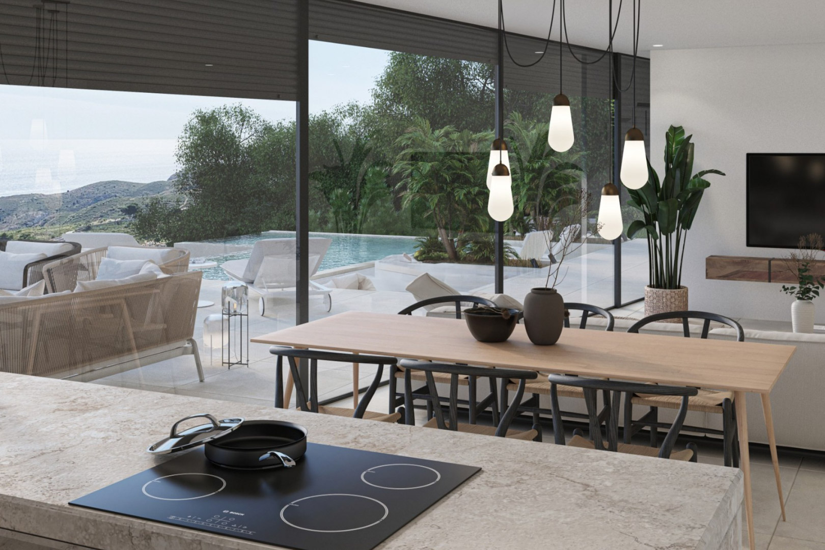 Espace de vie ouvert avec îlot de cuisine en pierre, luminaires design et baies vitrées offrant une vue dégagée sur la piscine à débordement et la mer.