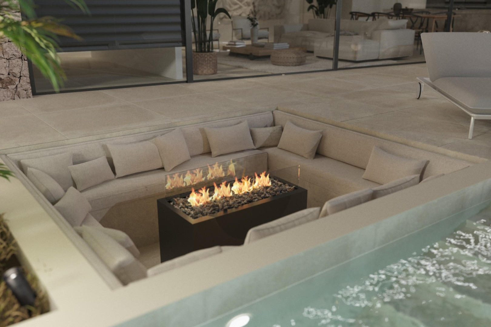 Espace détente extérieur encastré avec banquettes intégrées et foyer central, situé sur la terrasse à côté de la piscine.