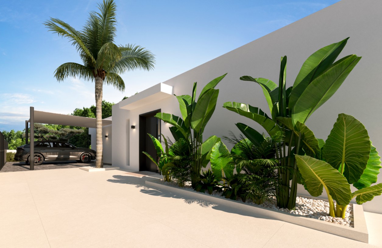 Entrée principale au design minimaliste avec porte sombre, jardinières de pierres blanches et plantes tropicales. Un abri de voiture couvert est adjacent à la villa.