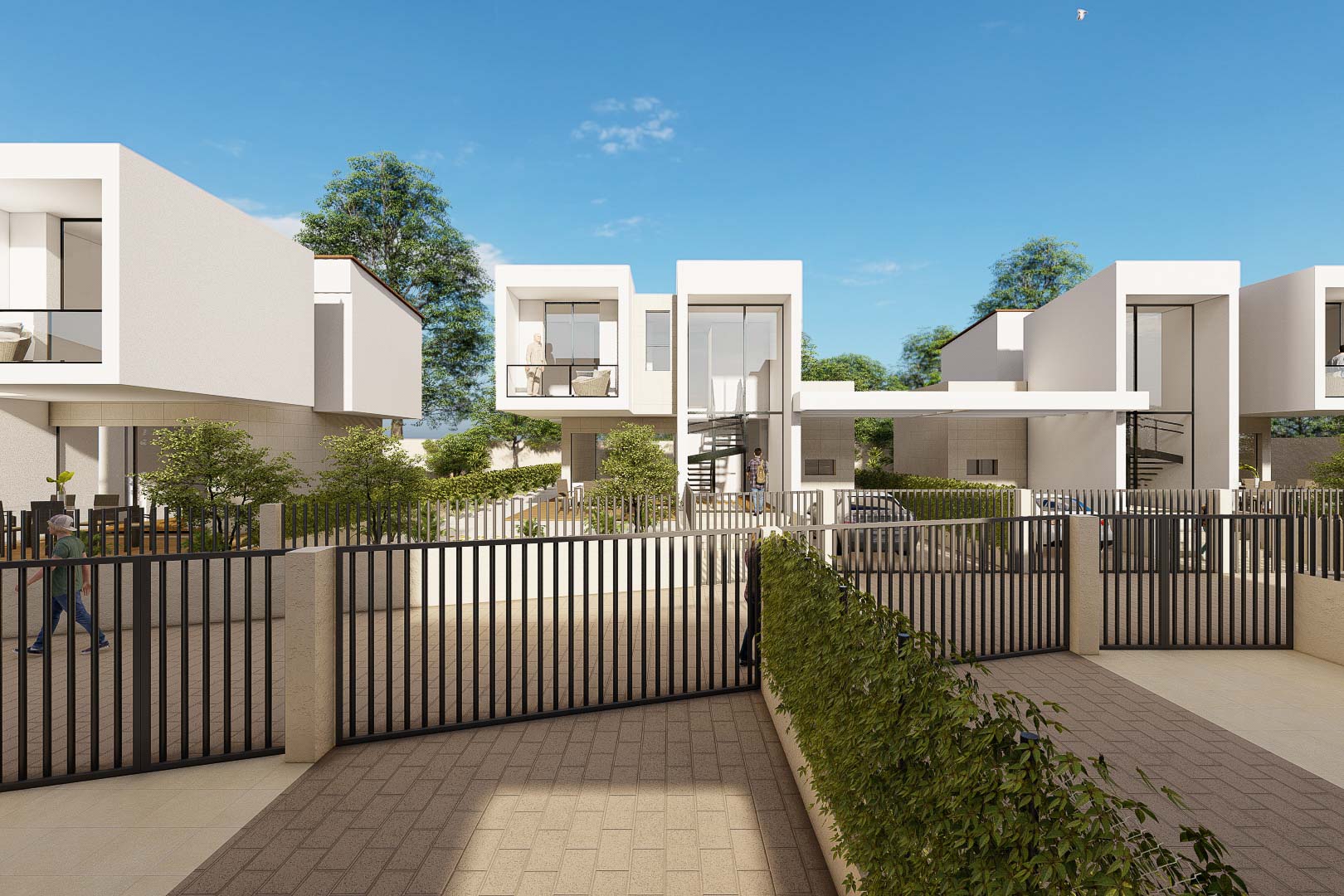 Vue extérieure des villas aux façades blanches et grandes baies vitrées. L'architecture cubique est complétée par des clôtures noires et un accès pavé privé sécurisé.