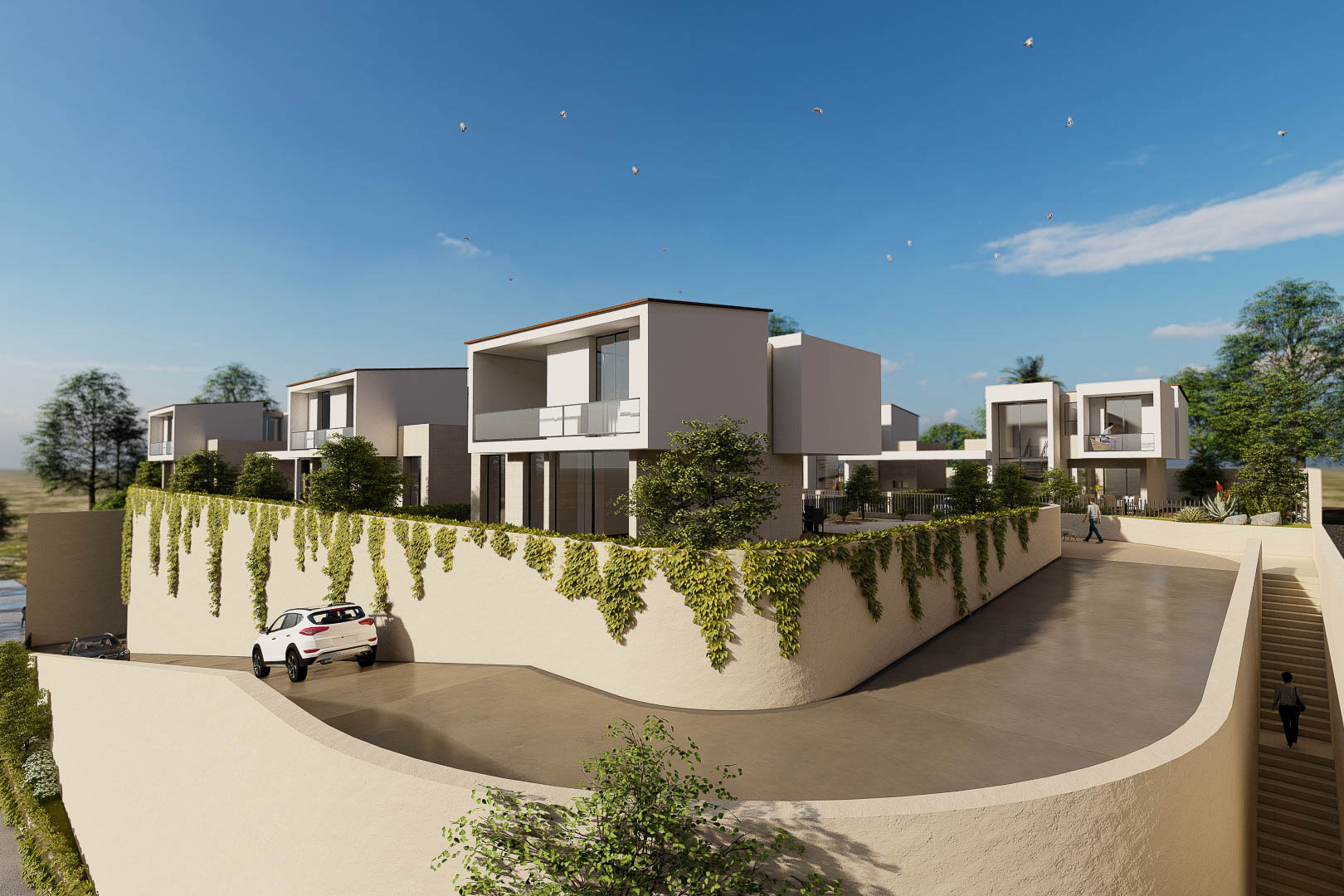 Vue extérieure du complexe résidentiel aux villas cubiques modernes, avec balcons vitrés et murs de soutènement végétalisés bordant l'accès privé.