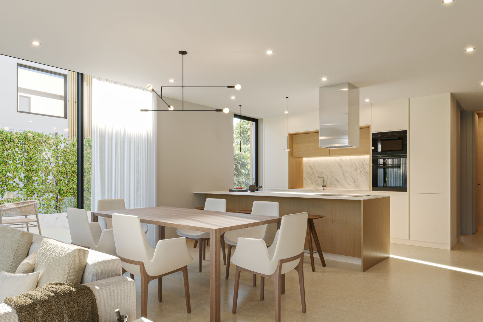 Espace de vie ouvert avec cuisine moderne en bois, îlot central, plan de travail en marbre et salle à manger lumineuse bordée de baies vitrées.