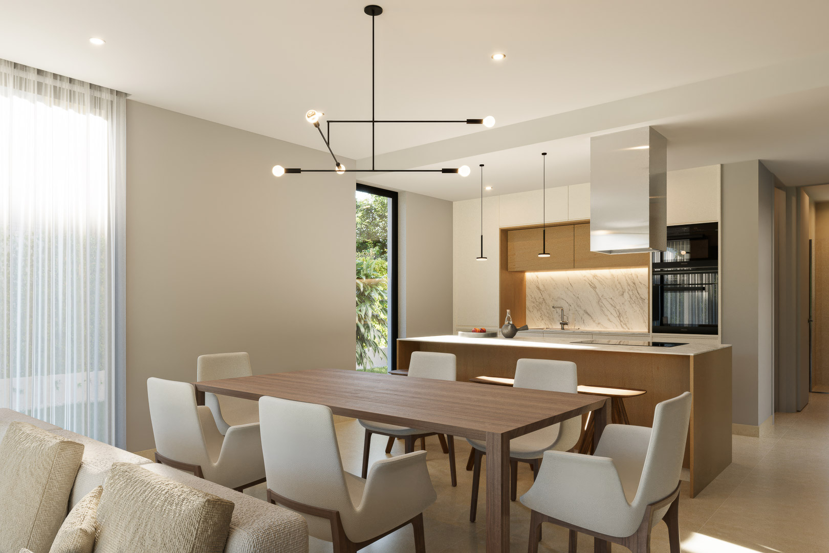 Espace dînatoire ouvert sur une cuisine moderne avec îlot en marbre, menuiseries en bois et luminaire géométrique noir, baigné de lumière naturelle.