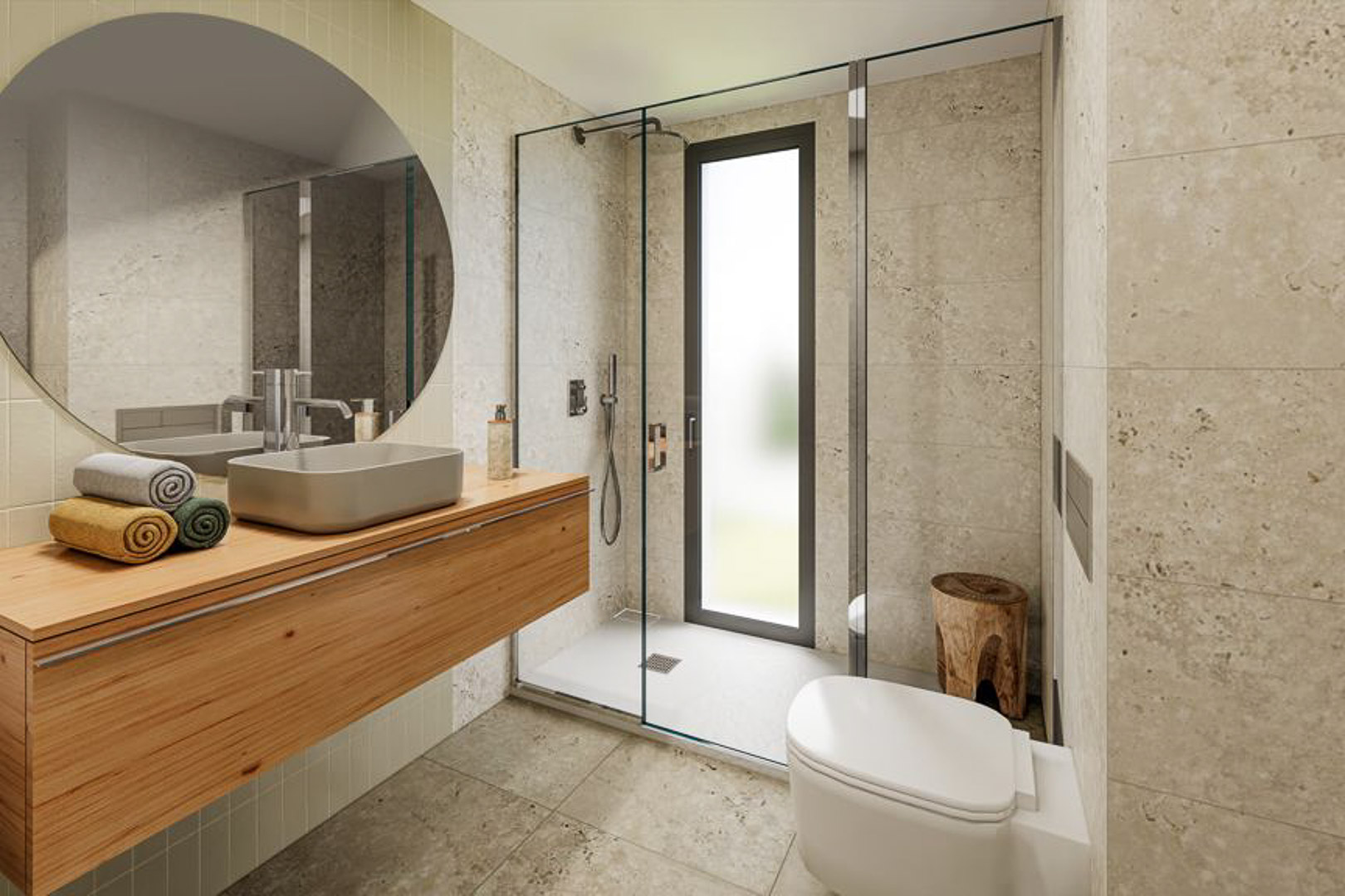 Salle de bain moderne avec meuble vasque en bois suspendu et miroir circulaire. Douche à l'italienne avec paroi vitrée et finitions murales en pierre naturelle aux tons clairs.