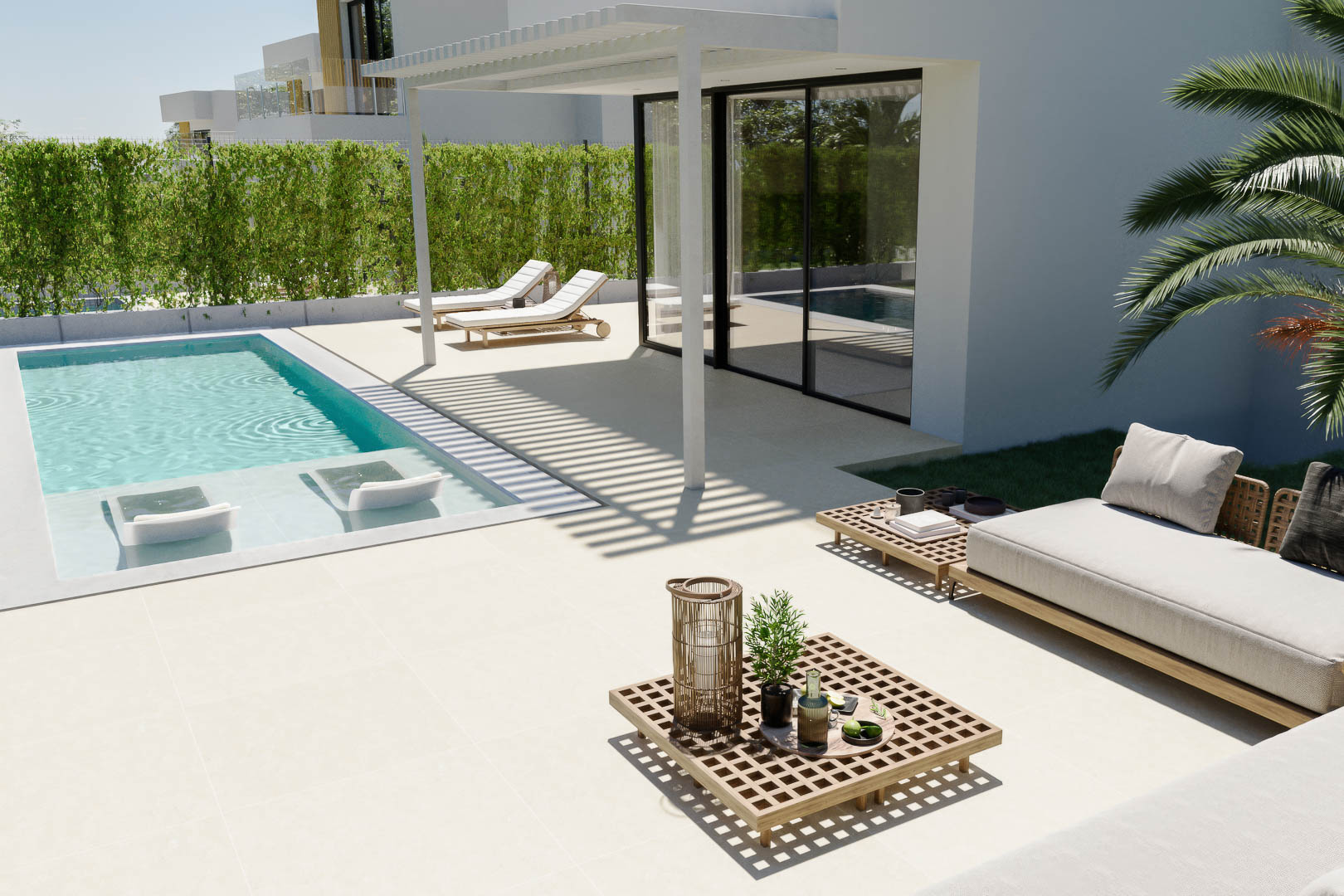 Terrasse extérieure avec piscine privée, bains de soleil immergés et espace détente avec mobilier en bois sous une pergola à lamas.