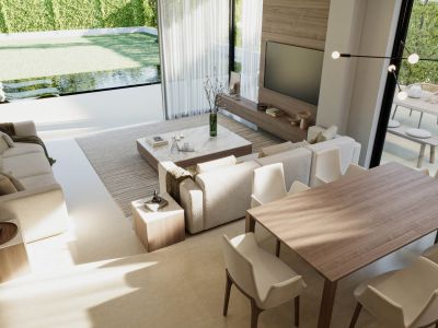 Vue du salon-salle à manger avec canapés rembourrés, table à manger en bois et accès au jardin avec piscine.
