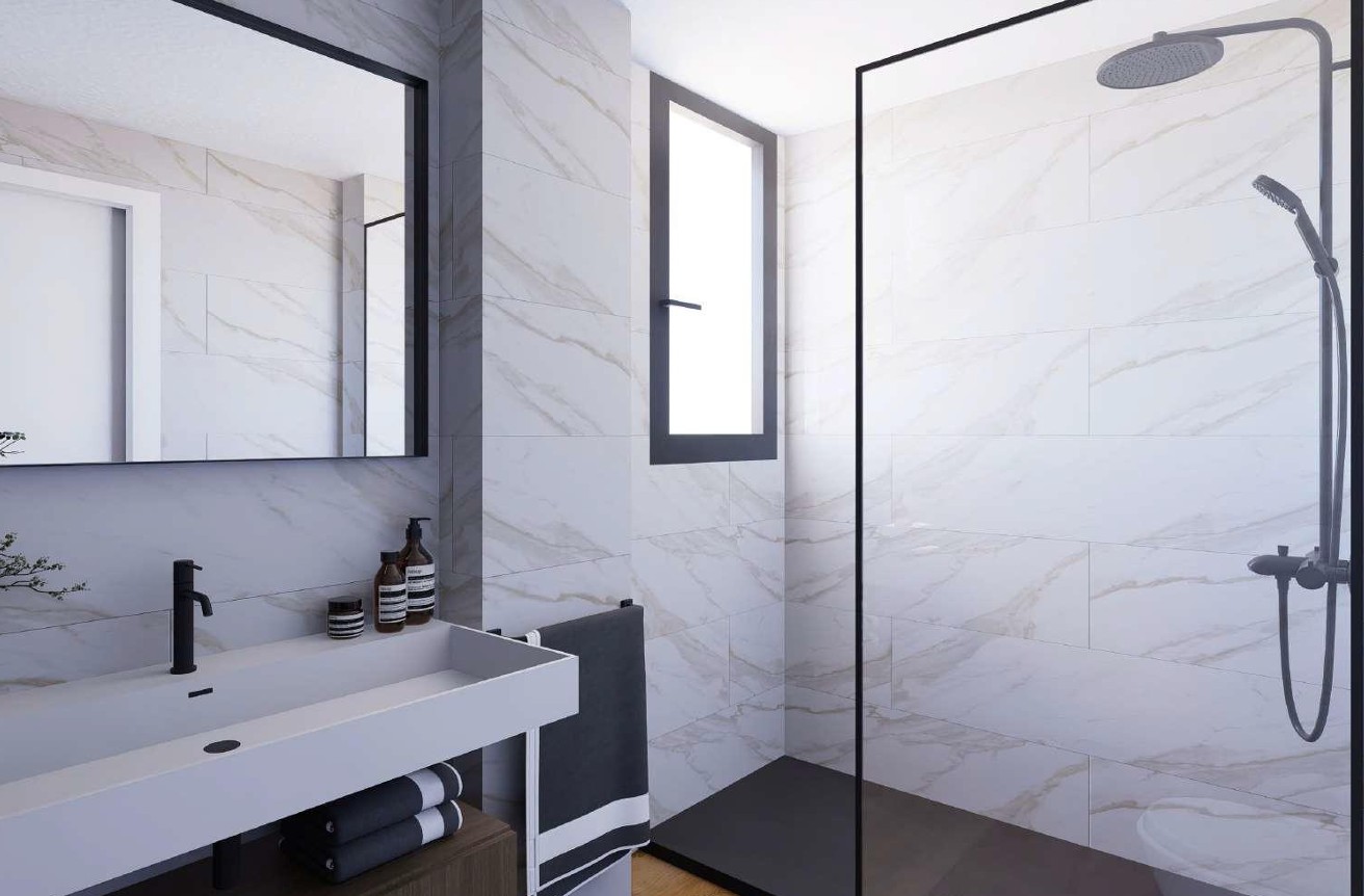 Salle de bains moderne avec carrelage effet marbre Porcelanosa, douche à l'italienne aux finitions noires et vasque intégrée avec robinetterie design.
