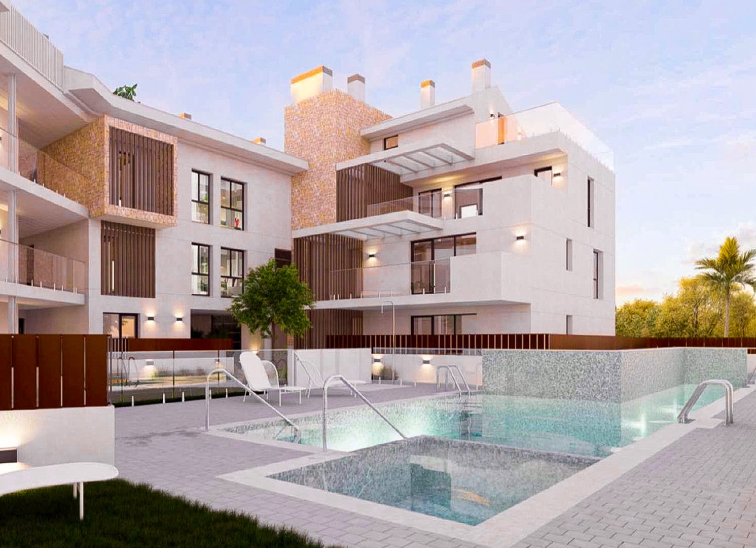 Vue extérieure du complexe avec piscine commune éclairée, façades blanches ornées de pierre naturelle et terrasses spacieuses avec garde-corps en verre.