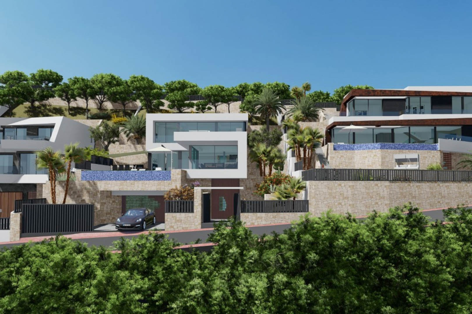 Vue extérieure de la villa moderne avec architecture cubique, murs en pierre naturelle, piscines à débordement en mosaïque bleue et jardins en terrasses.