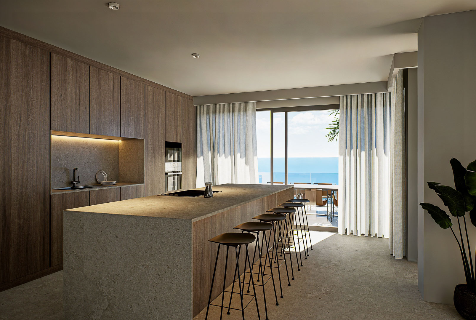 Cuisine de design avec îlot central en pierre, menuiserie en bois naturel et grandes baies vitrées s'ouvrant sur une terrasse avec vue imprenable sur la mer.