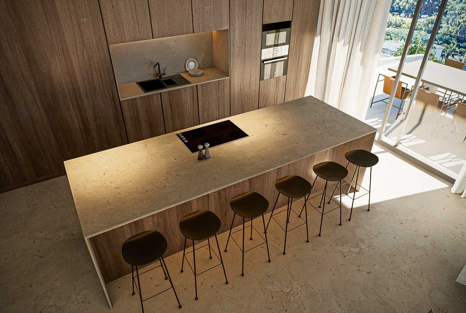 Cuisine de design avec îlot central en pierre, tabourets minimalistes et placards en bois toute hauteur. La lumière naturelle pénètre par les grandes baies vitrées de la terrasse.
