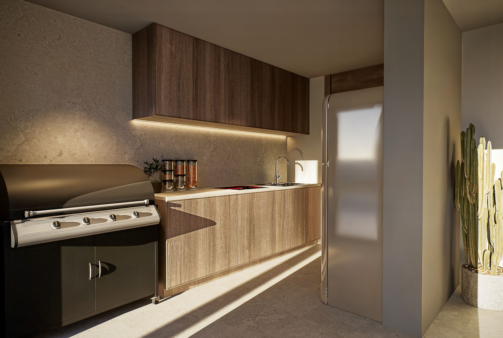 Cuisine d'été avec barbecue intégré, meubles en bois, plan de travail en pierre et réfrigérateur rétro baigné de lumière naturelle.