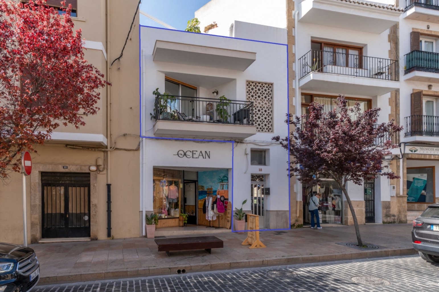 Façade de l'immeuble rénové avec balcon et boutique 'Ocean' dans le centre historique de Jávea.