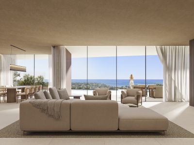 Espace salon-salle à manger ouvert avec canapé modulaire, baies vitrées et vue sur la mer, complété par une table à manger en bois.