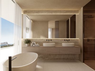 Salle de bain principale avec baignoire en pierre autoportante, double vasque et vue mer panoramique par de larges fenêtres.
