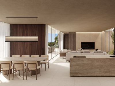 Vaste espace de vie ouvert intégrant salle à manger avec vue sur mer, îlot de cuisine en pierre et salon donnant sur un jardin intérieur, séparés par de grandes baies vitrées.