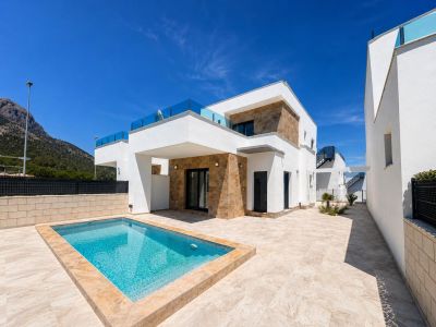 L'extérieur de la villa moderne présente une piscine privée rectangulaire et une vaste terrasse carrelée claire. Façades blanches avec pierre naturelle et balustrades en verre encadrent la vue sur la montagne.
