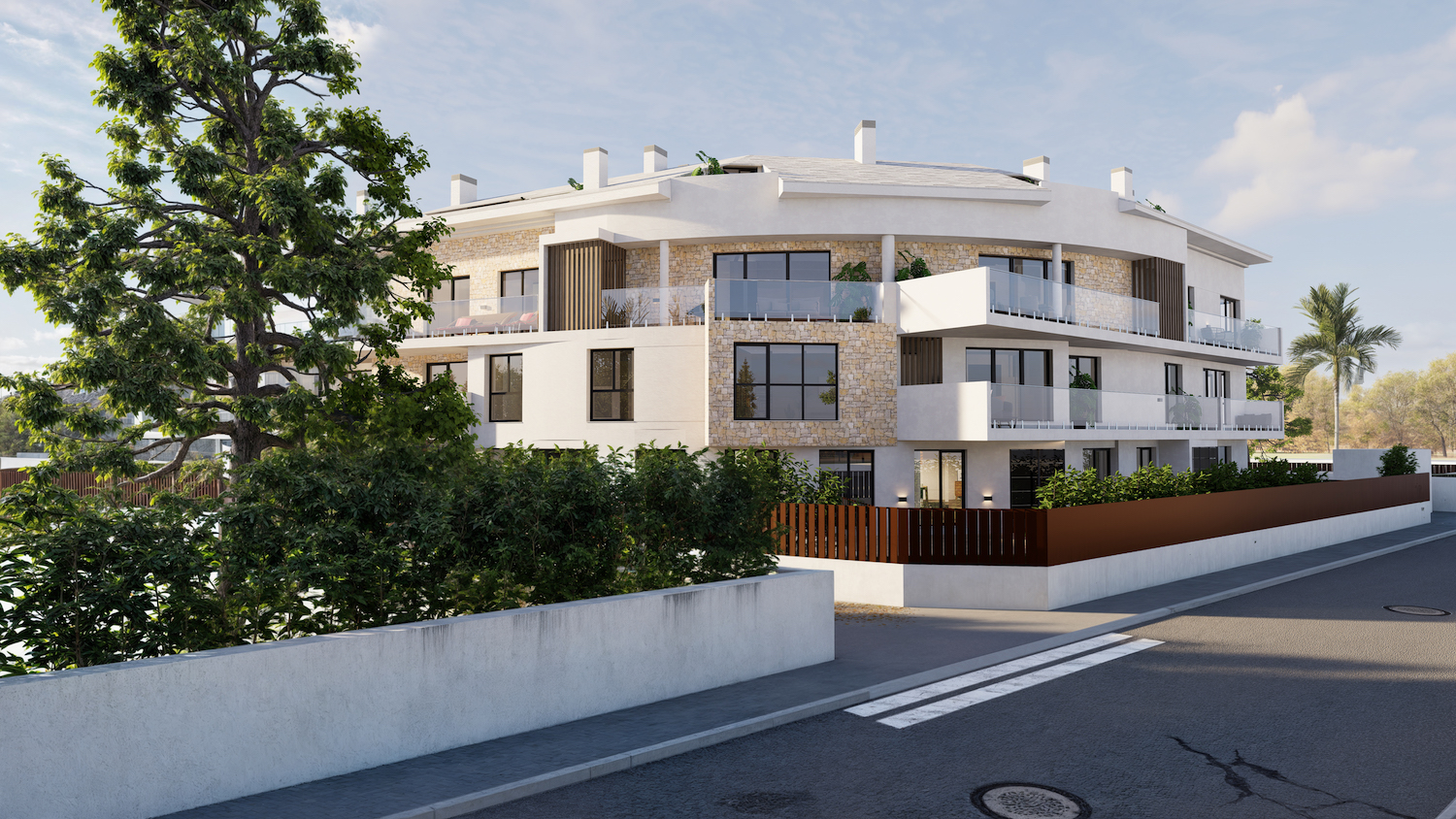 Immeuble d'appartements moderne à façade courbe, combinant stuc blanc et revêtement en pierre naturelle, avec balcons vitrés. La verdure méditerranéenne encadre la propriété.