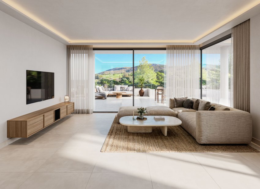 Salon moderne avec canapé d'angle neutre, table basse ovale et meuble TV suspendu en bois. Les baies vitrées mènent à une terrasse spacieuse avec vues panoramiques sur les collines verdoyantes.