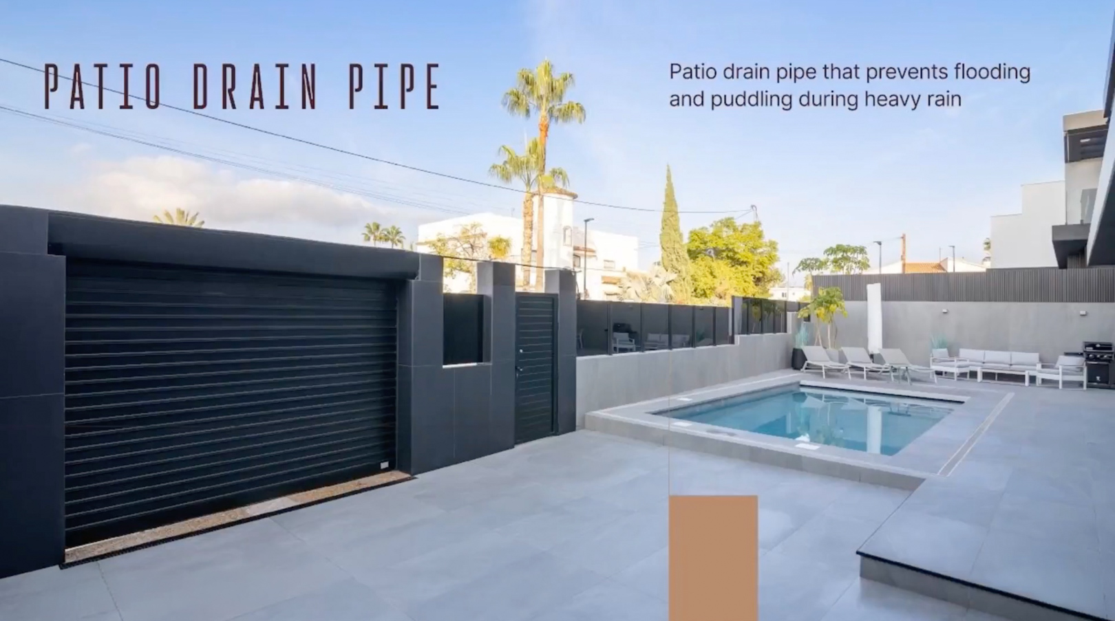 Vaste patio extérieur avec piscine, revêtement de sol carrelé gris clair et porte de garage noire moderne. Un drain de terrasse intégré prévient les inondations. Vaste patio extérieur avec piscine, revêtement de sol carrelé gris clair et porte de garage noire moderne. Un drain de terrasse intégré prévient les inondations.