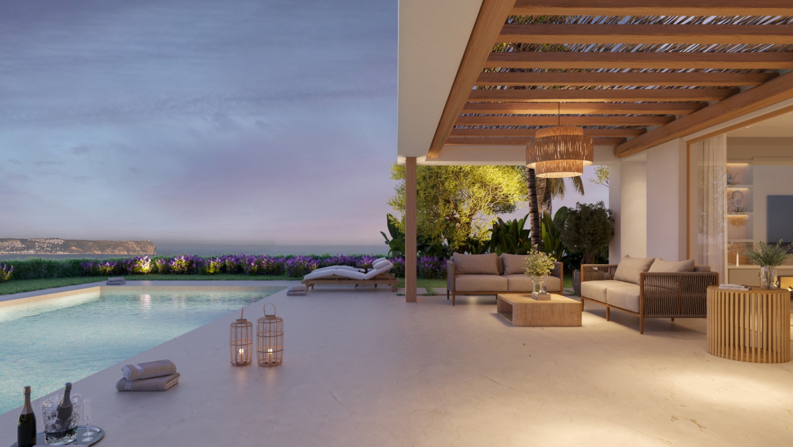 Terrasse en pierre avec pergola en bois et salon extérieur bordant une piscine à débordement avec vue sur mer au crépuscule. L'éclairage chaleureux souligne les matériaux naturels.