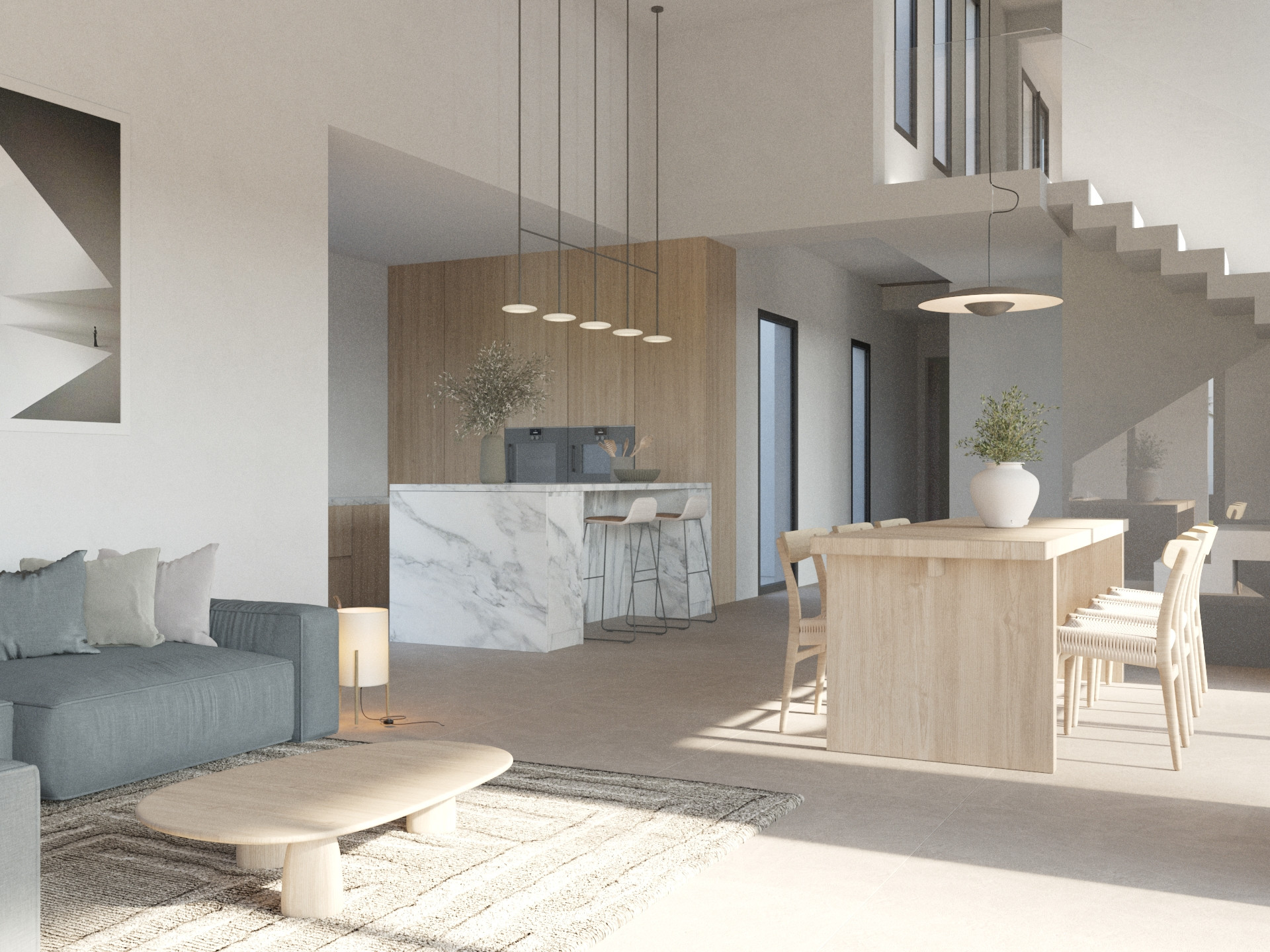 Espace de vie ouvert comprenant un îlot de cuisine en marbre, une table à manger en bois et un salon contemporain avec canapé bleu-gris et escalier minimaliste.