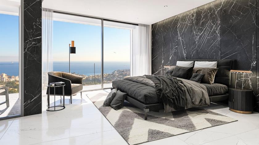 Chambre principale avec mur d'accent en marbre, lit double et vue panoramique sur la mer Méditerranée.
