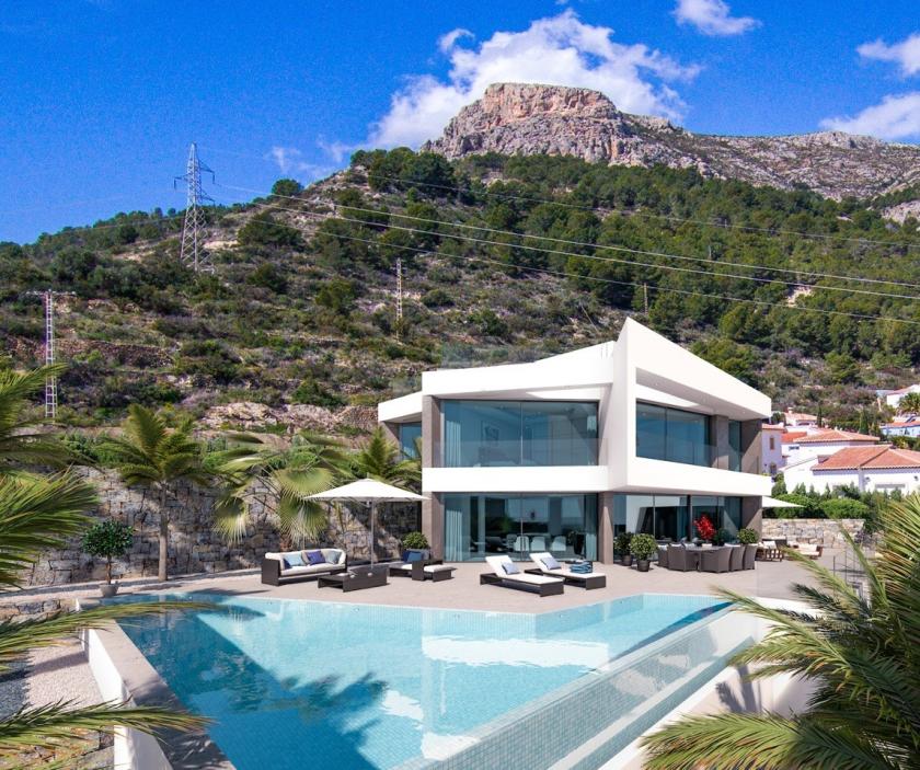 Vue extérieure de la villa avec piscine à débordement et coin salon, avec vue sur la montagne.