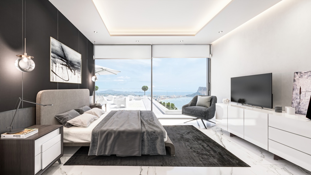 Chambre avec lit double, tapis foncé et vue sur la mer à travers de grandes fenêtres.