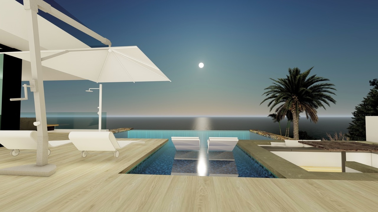 Vue sur la piscine à débordement avec chaises longues immergées et grand parasol, face à la mer.