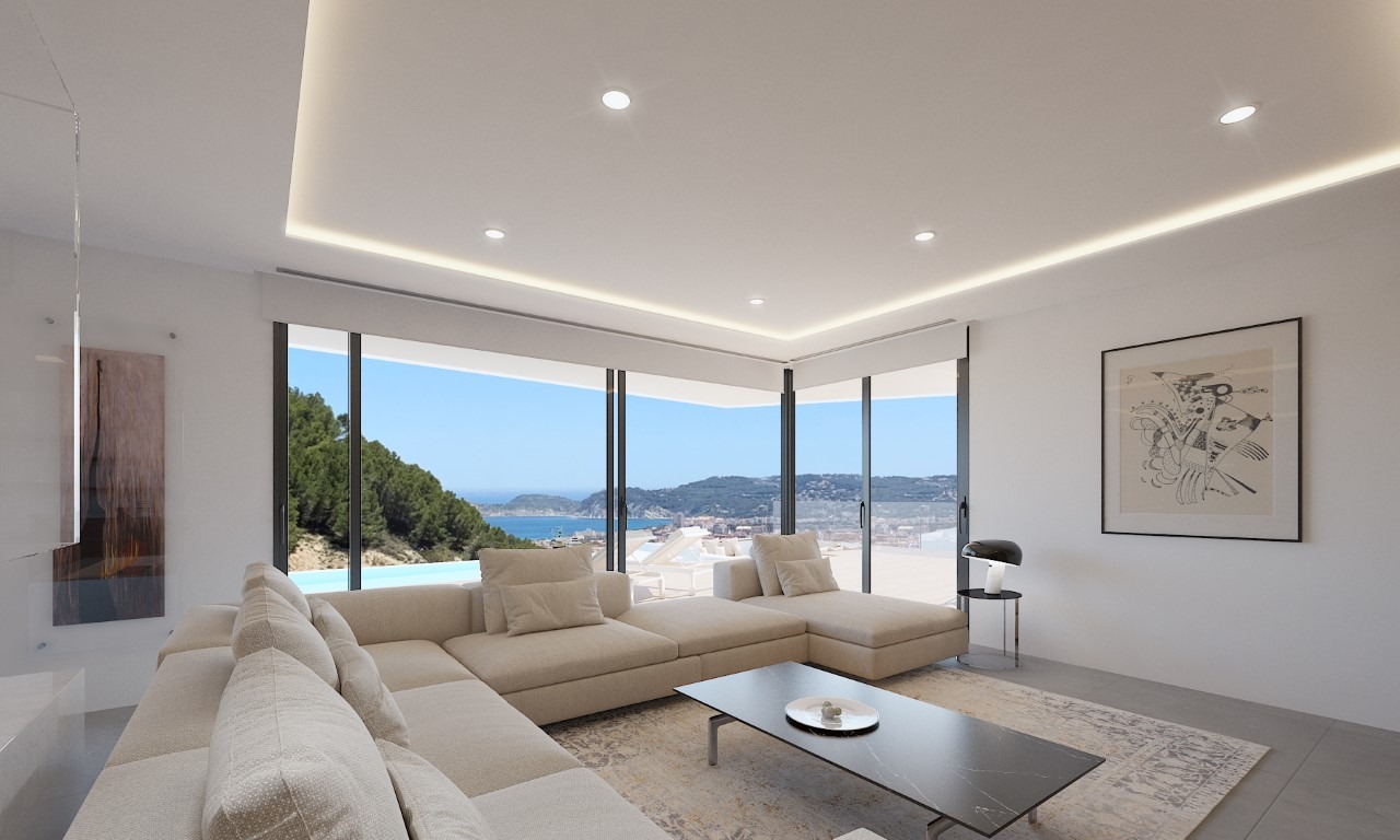 Salon lumineux avec éclairage LED indirect, mobilier minimaliste et grandes baies vitrées offrant une vue panoramique sur la mer et la côte de Jávea.
