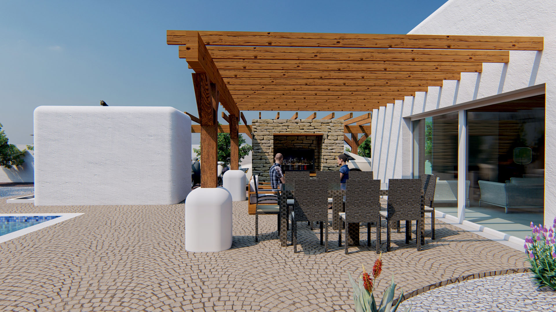 Espace repas extérieur sous une pergola en bois, comprenant un mur en pierre naturelle avec foyer et une terrasse en pavés près de la piscine.