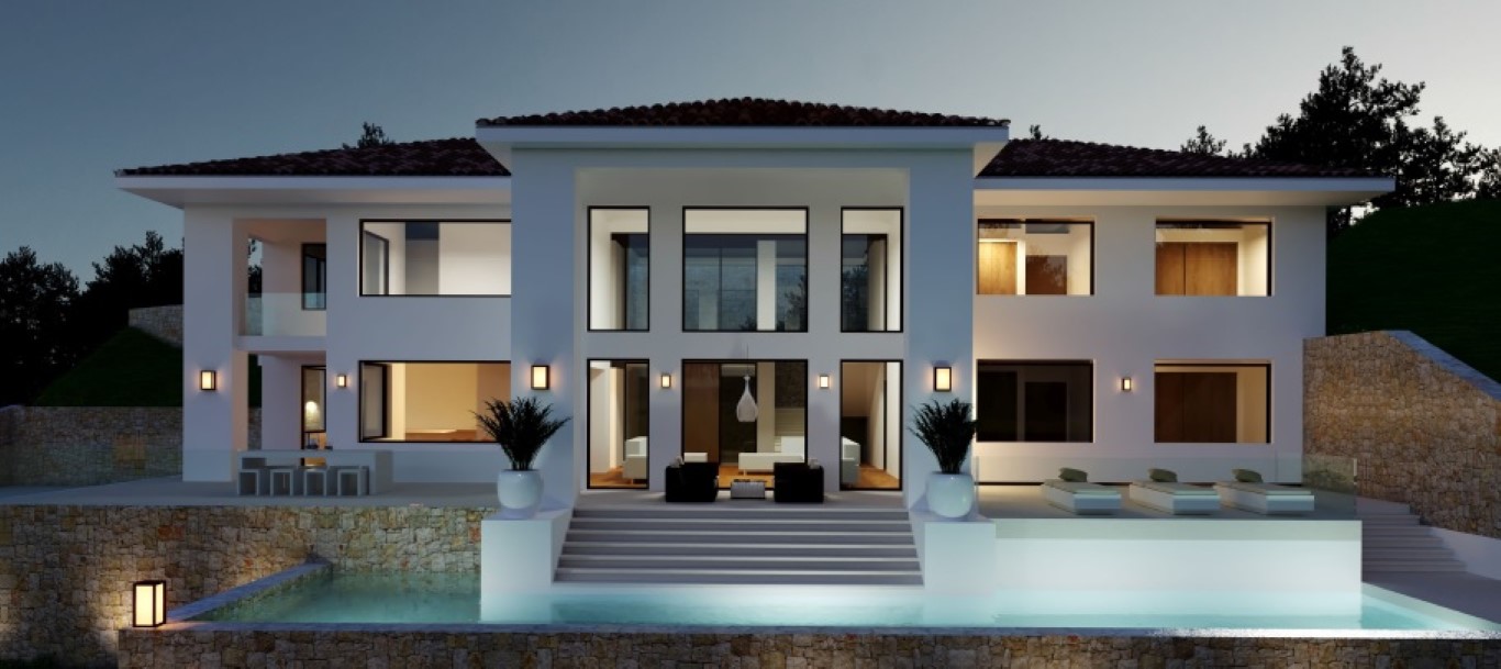 Façade extérieure de la villa au crépuscule, présentant une piscine à débordement, des murs en pierre et de grandes baies vitrées lumineuses.