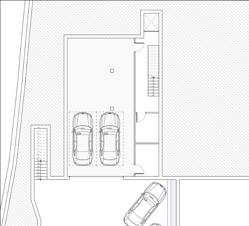Plan technique du niveau garage illustrant les emplacements de stationnement, l'accès par ascenseur et l'escalier intérieur menant aux étages.