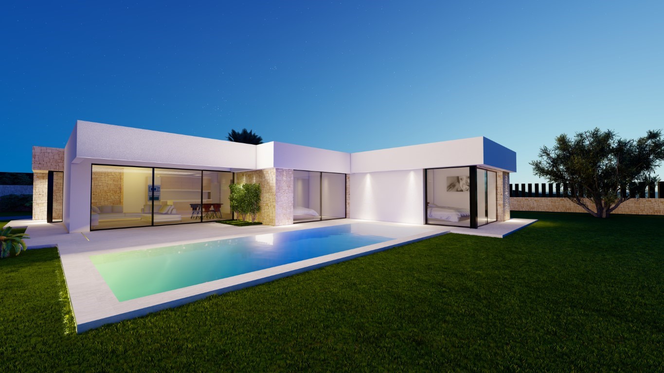 Vue nocturne de la villa avec piscine rectangulaire, façade blanche et murs en pierre. Les larges baies vitrées révèlent l'intérieur lumineux et le jardin soigné.