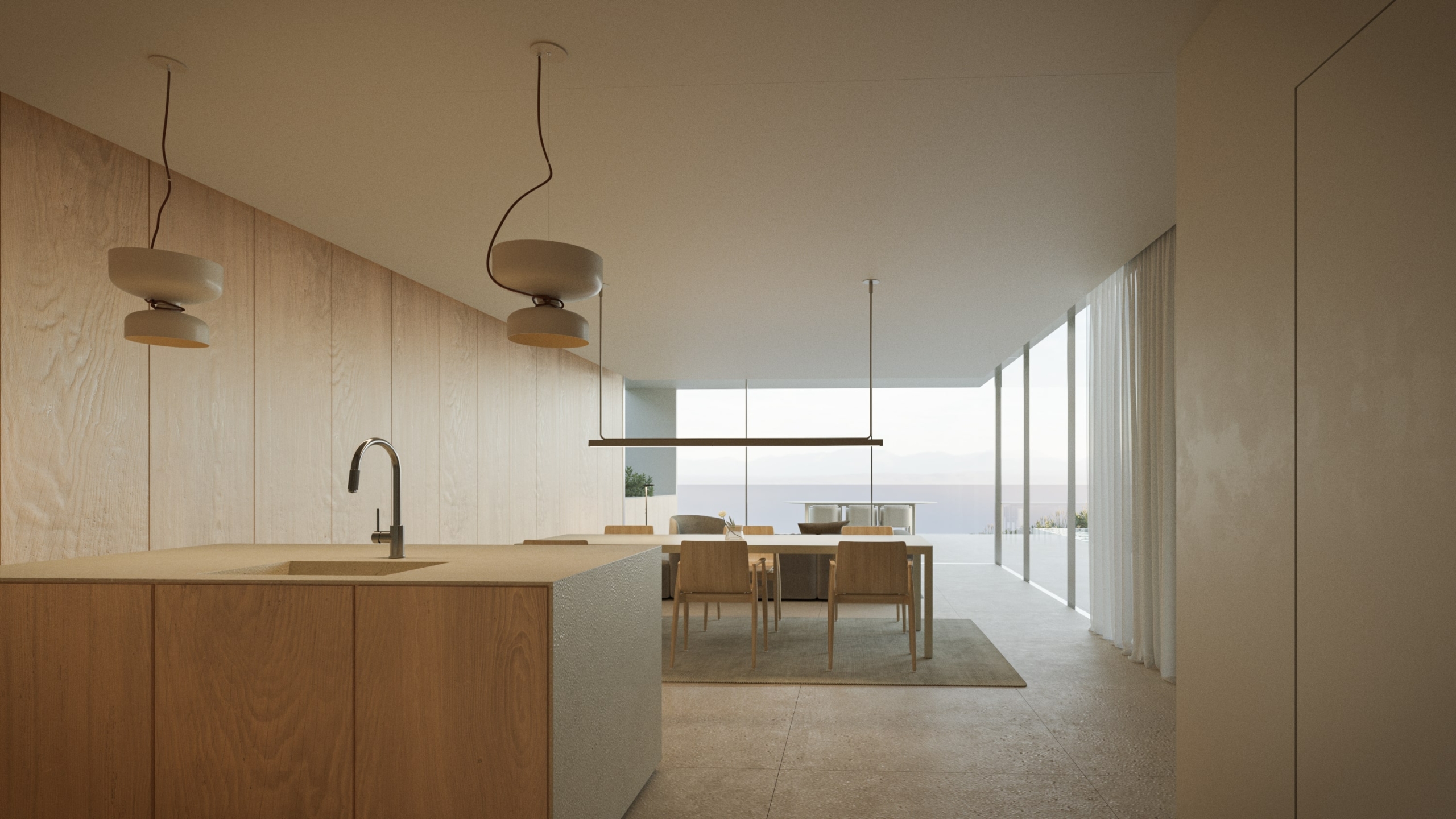 Cuisine moderne avec îlot en bois, luminaires design et salle à manger lumineuse s'ouvrant sur une terrasse avec vue imprenable sur la mer.