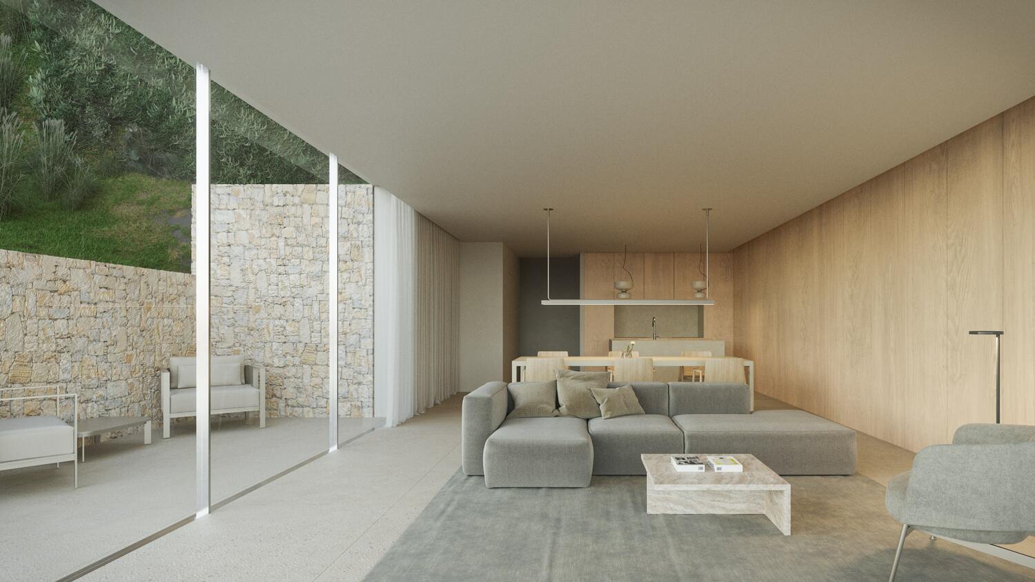 Salon ouvert avec canapé d'angle gris, murs en boiserie claire et grandes baies vitrées donnant sur un patio extérieur en pierre naturelle.