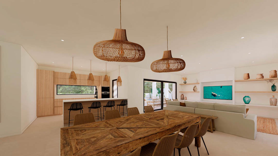 Espace de vie ouvert comprenant une salle à manger avec table en bois, un salon épuré et une cuisine équipée, le tout éclairé par des suspensions en osier.