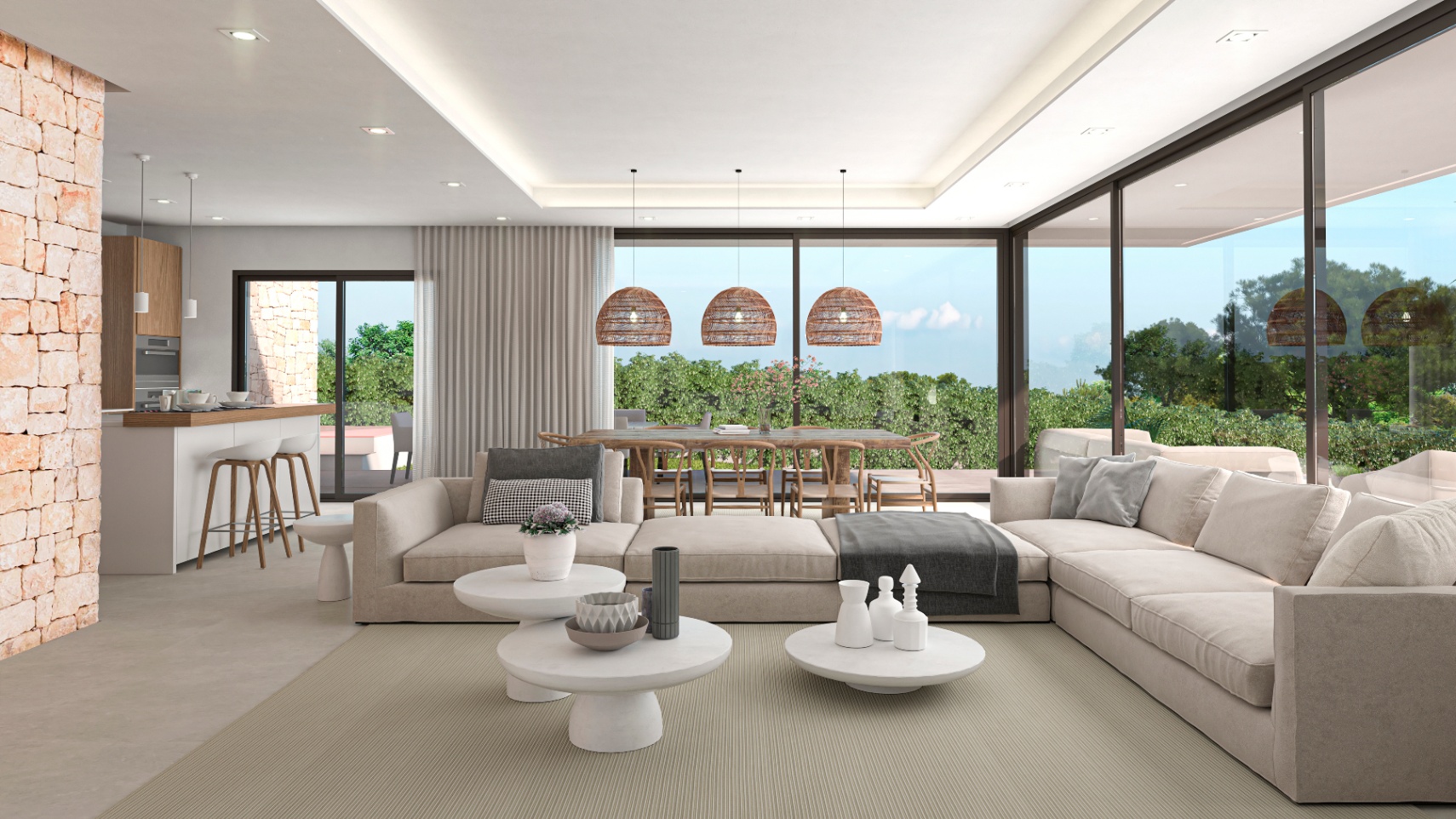 Salon lumineux avec mur en pierre apparente, canapés modulables beiges et vue sur le jardin.
