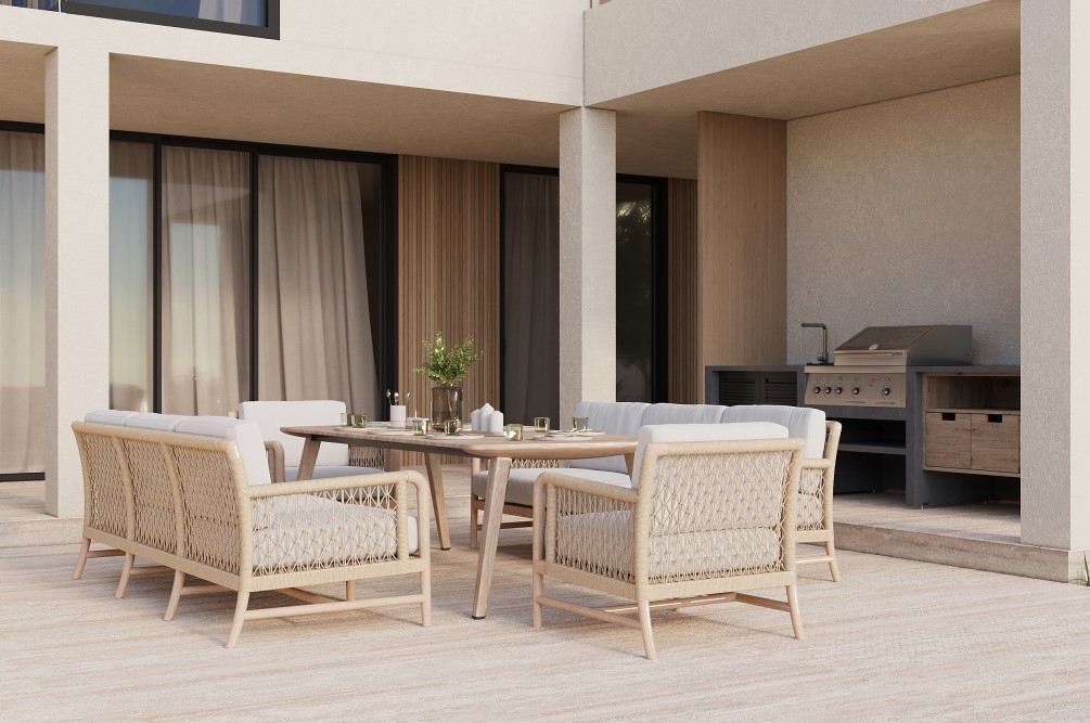 Salle à manger extérieure couverte avec mobilier en rotin et cuisine extérieure avec barbecue.