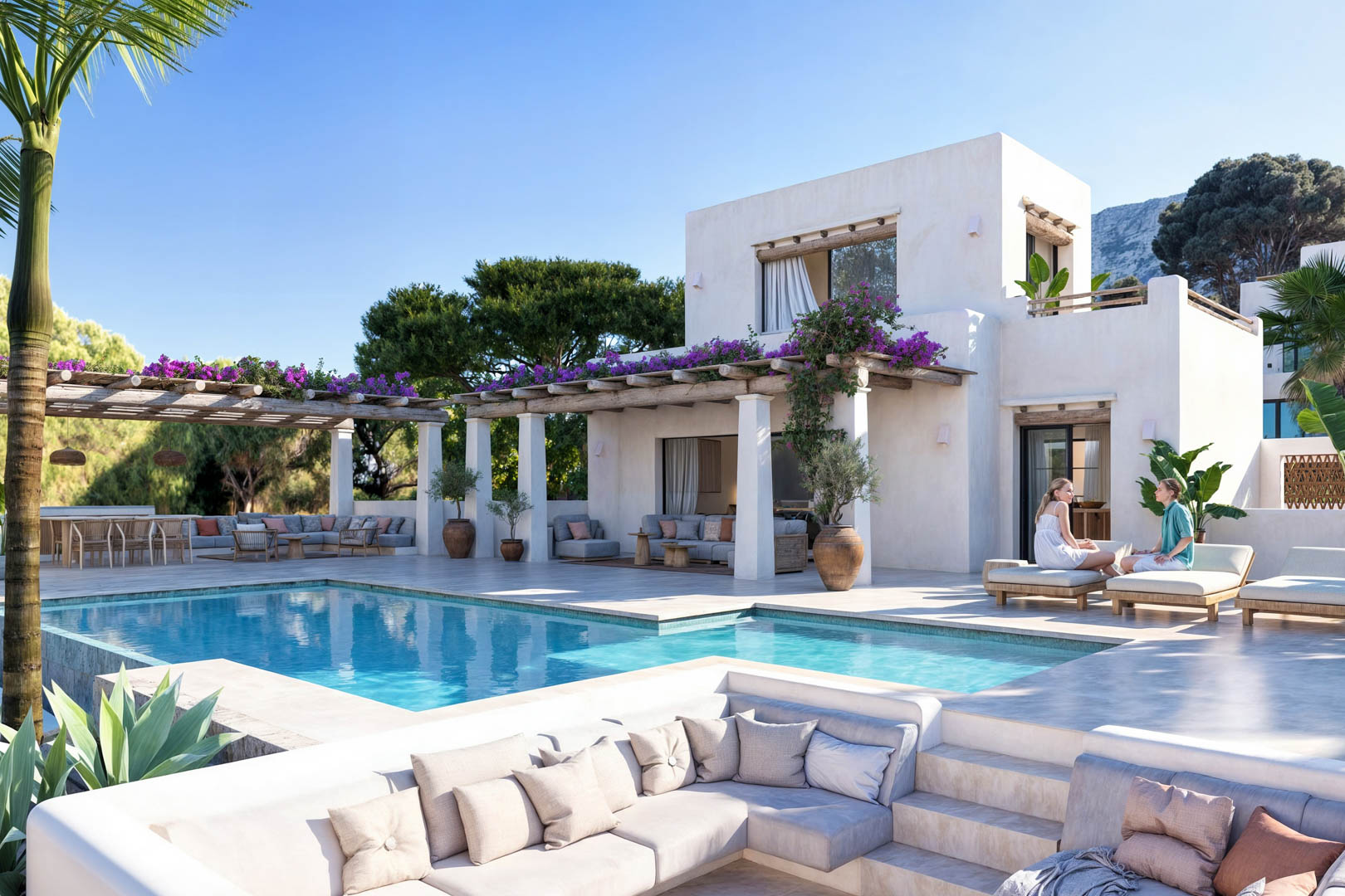 Vue sur la piscine avec pergola couverte de bougainvilliers et coin salon avec canapés intégrés.