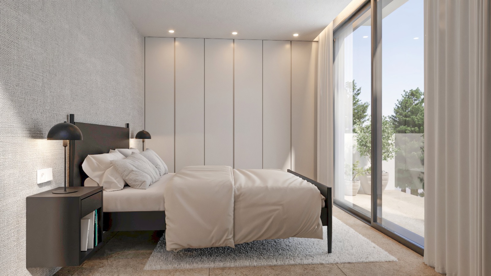 Chambre moderne avec placards intégrés, éclairage encastré et grandes baies vitrées coulissantes offrant un accès direct à une terrasse privée ensoleillée.