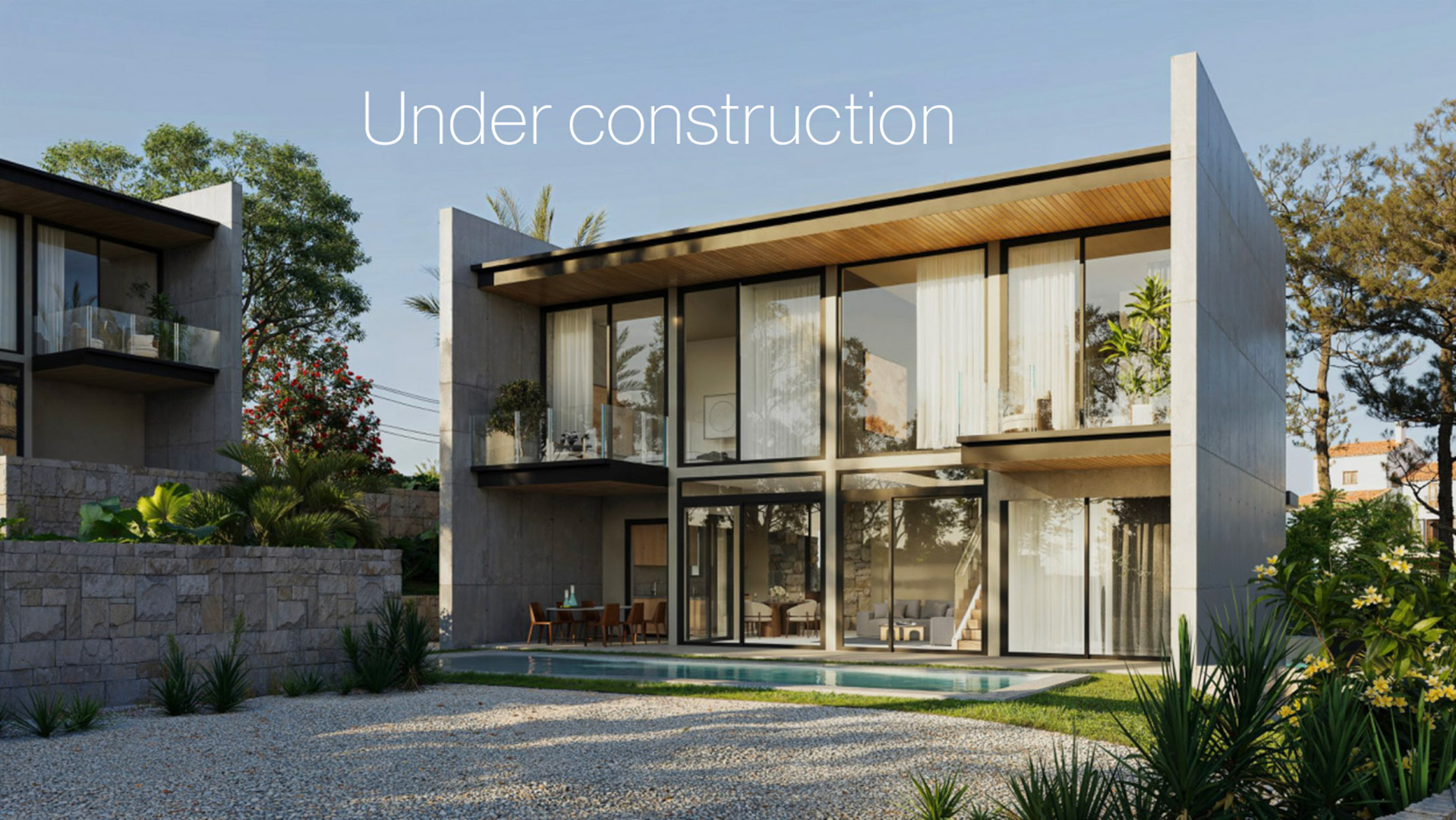 Façade moderne en béton et verre avec de grandes baies vitrées, des balcons privés à l'étage et une piscine bordant l'espace de vie extérieur.