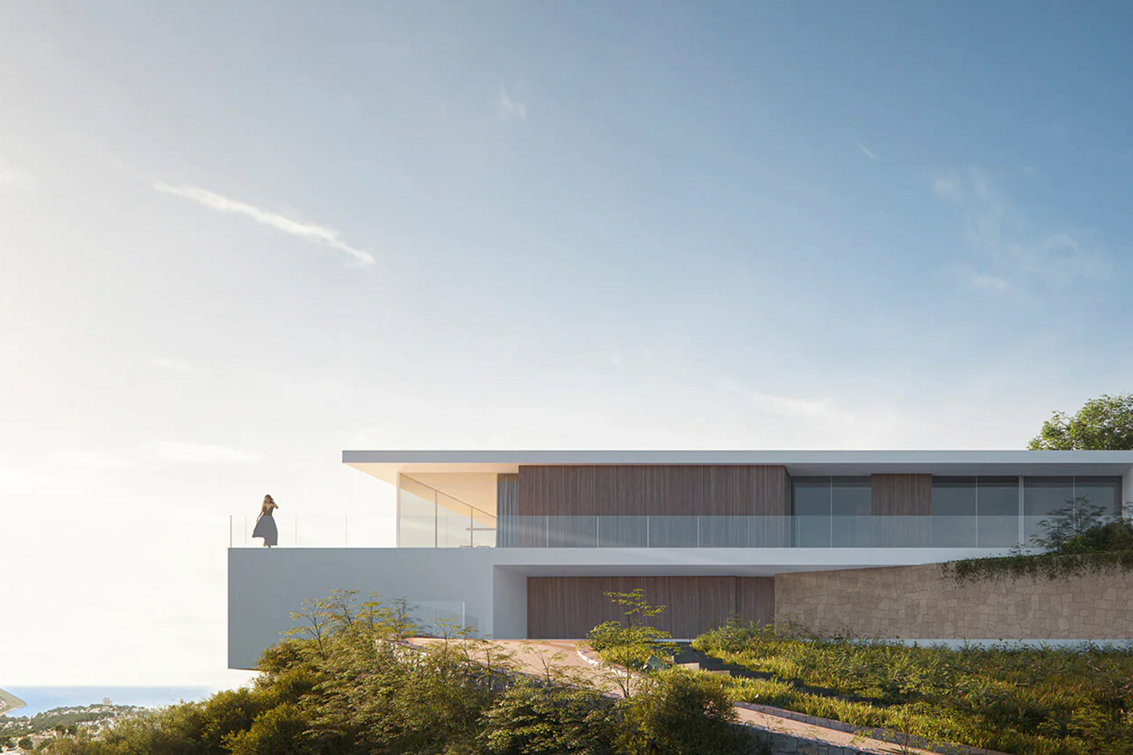 Façade contemporaine aux lignes épurées avec bardage en bois et murs en pierre, disposant d'une terrasse panoramique surplombant la mer et le paysage.