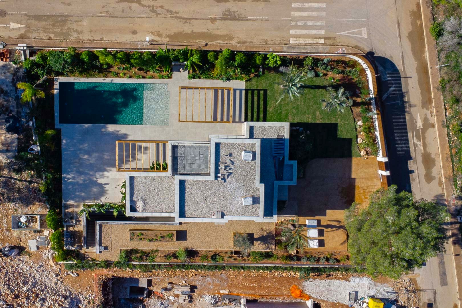 Vue aérienne zénithale de la propriété révélant l'agencement de la villa, la piscine de style Bali, les pergolas en bois et le jardin méditerranéen paysager.