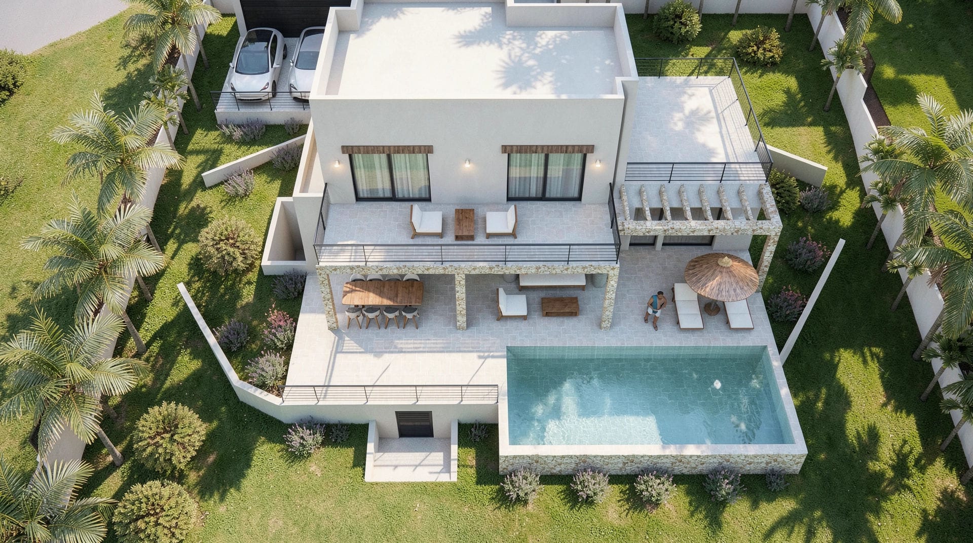 Vue aérienne de la villa moderne avec piscine rectangulaire, terrasses sur deux niveaux ornées de pierre naturelle et jardin paysager avec palmiers.